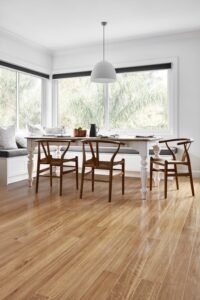 Close-up view of hybrid flooring with a natural wood grain finish in a modern living room